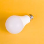 white light bulb on yellow surface
